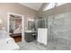 The main bathroom features grey cabinets, a double sink, large mirror, a glass shower, and a tub at 176 Nightwind Trce, Acworth, GA 30101