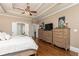 The main bedroom features hardwood floors, decorative ceilings, and two dressers with a flat screen TV on top of one at 176 Nightwind Trce, Acworth, GA 30101