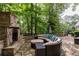 Inviting outdoor fireplace and patio with comfortable seating for relaxing or entertaining guests at 176 Nightwind Trce, Acworth, GA 30101