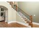A staircase featuring wood steps and an iron railing detail, with hardwood floors at 176 Nightwind Trce, Acworth, GA 30101