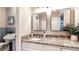 Quaint bathroom with granite vanity, two decorative mirrors and views into the tiled shower area at 2735 Shetland Dr, Decatur, GA 30033