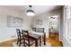 A dining room leading into a living room with dark wood table and light walls at 2735 Shetland Dr, Decatur, GA 30033