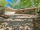 Inviting brick home with a two-car garage, a brick paver driveway, and attractive landscaping for enhanced curb appeal at 2735 Shetland Dr, Decatur, GA 30033