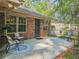 Cozy brick patio with seating arrangement, perfect for outdoor relaxation, and quaint chandelier lighting at 2735 Shetland Dr, Decatur, GA 30033