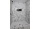 A modern shower features marble-style tile, a built-in niche, and a glass surround for a spa-like experience at 6454 Boca Grande Blvd, Forest Park, GA 30297