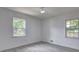 A bright bedroom features two windows offering natural light and wood-look floors for a modern feel at 6454 Boca Grande Blvd, Forest Park, GA 30297