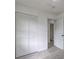 The bedroom includes a closet with a slatted doors that open, and modern floors at 6454 Boca Grande Blvd, Forest Park, GA 30297