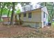 Exterior backyard view of home with deck and walkout basement at 6454 Boca Grande Blvd, Forest Park, GA 30297