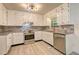 Cozy kitchen featuring white cabinets, stainless steel appliances, and granite countertops at 6454 Boca Grande Blvd, Forest Park, GA 30297