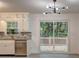 Well-equipped kitchen featuring white cabinets, stainless steel appliances, and granite countertops at 6454 Boca Grande Blvd, Forest Park, GA 30297