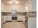 Modern kitchen featuring white cabinets, stainless steel appliances, and granite countertops at 6454 Boca Grande Blvd, Forest Park, GA 30297