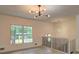 Bright open living room showcasing wood floors, modern lighting, and stairs at 6454 Boca Grande Blvd, Forest Park, GA 30297