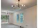 Spacious open living room showcasing wood floors, modern lighting, and access to a deck at 6454 Boca Grande Blvd, Forest Park, GA 30297