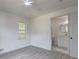 A light-filled main bedroom with wood-look flooring and ensuite bathroom access offers a serene retreat at 6454 Boca Grande Blvd, Forest Park, GA 30297