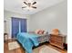 Comfortable bedroom with a ceiling fan, wood floors, and a cozy rug, bathed in soft natural light at 898 Allene Sw Ave, Atlanta, GA 30310