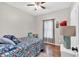 Cozy bedroom with hardwood floors, ceiling fan, and floral bedding, creating a comfortable retreat at 898 Allene Sw Ave, Atlanta, GA 30310