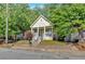 Charming front exterior view of the house featuring a yellow front door and a cozy front porch at 898 Allene Sw Ave, Atlanta, GA 30310