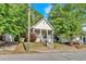Charming front exterior view of the house featuring a yellow front door and a cozy front porch at 898 Allene Sw Ave, Atlanta, GA 30310