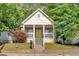 Charming front exterior view of the house featuring a yellow front door and a cozy front porch at 898 Allene Sw Ave, Atlanta, GA 30310