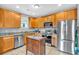 Well-lit kitchen with wooden cabinetry, stainless steel appliances, and granite countertops at 898 Allene Sw Ave, Atlanta, GA 30310