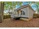 Side view of the house's exterior, which is painted gray with a white deck and stairs at 898 Allene Sw Ave, Atlanta, GA 30310