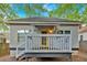 Exterior shot of the rear of the home, featuring a grey paint, a yellow back door, and a small deck at 898 Allene Sw Ave, Atlanta, GA 30310