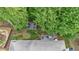 An aerial view featuring a deck with seating surrounded by mature trees and a roof top at 905 Fox Croft Pl, Canton, GA 30114