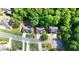 Bird's eye view of houses on a tree-lined street, surrounded by lush landscapes, showing neighborhood layout and property settings at 905 Fox Croft Pl, Canton, GA 30114