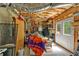 Unfinished basement showcasing exposed ceiling insulation, framing, and doorway to the outside at 905 Fox Croft Pl, Canton, GA 30114