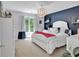 Bedroom with blue accent wall, white furniture, and a window at 905 Fox Croft Pl, Canton, GA 30114