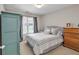 Bedroom with neutral walls, grey bedding, a dresser, and a window at 905 Fox Croft Pl, Canton, GA 30114