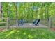 Fenced backyard deck featuring a seating area surrounded by green grass and trees at 905 Fox Croft Pl, Canton, GA 30114