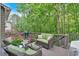 Outdoor deck features comfortable seating with throw pillows, glass topped table, and a grill at 905 Fox Croft Pl, Canton, GA 30114