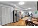 Well-lit dining area featuring a refrigerator and open workspace at 905 Fox Croft Pl, Canton, GA 30114