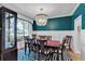 Formal dining room with elegant chandelier, dark wood table, and stylish wainscoting at 905 Fox Croft Pl, Canton, GA 30114