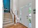 Inviting foyer with hardwood floors, staircase, and natural light from side windows at 905 Fox Croft Pl, Canton, GA 30114