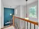 Bright hallway with decorative lighting, wood railing and a view from the top of the stairs at 905 Fox Croft Pl, Canton, GA 30114