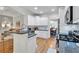 Kitchen showcases white cabinets, granite countertops, stainless appliances, and an open layout to living and dining areas at 905 Fox Croft Pl, Canton, GA 30114