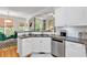 Kitchen includes stainless appliances, granite countertops, white cabinets, and a pass-through to breakfast nook at 905 Fox Croft Pl, Canton, GA 30114