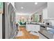 Bright open-concept kitchen connects seamlessly to the breakfast nook, featuring modern appliances and granite countertops at 905 Fox Croft Pl, Canton, GA 30114