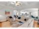 Bright and airy living room with hardwood floors and access to the kitchen at 905 Fox Croft Pl, Canton, GA 30114