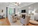 Spacious living room with coffered ceiling, hardwood floors, fireplace and floral curtains at 905 Fox Croft Pl, Canton, GA 30114