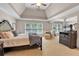 Bright main bedroom featuring a tray ceiling, sitting area, many windows, and neutral decor at 905 Fox Croft Pl, Canton, GA 30114
