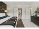 Bright main bedroom with neutral colors, a dark accent wall, stylish furnishings, and ensuite bathroom at 102 Holt Ln, Lawrenceville, GA 30046