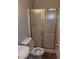 Small bathroom features a toilet, sink, and shower with framed sliding glass doors at 1170 Blair Bridge Rd, Austell, GA 30168