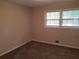 This bedroom features neutral walls and trim, carpet and window, and an air conditioning vent at 1170 Blair Bridge Rd, Austell, GA 30168