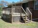 Outdoor deck with wooden railings and stairs leading to the yard at 1170 Blair Bridge Rd, Austell, GA 30168