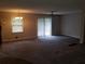 Spacious living room with ceiling fan, new carpet, and access to the outdoors at 1170 Blair Bridge Rd, Austell, GA 30168