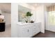 A bright bathroom with double vanity, stylish cabinets, and a view of the walk-in shower and soaking tub creates a spa-like experience at 1771 Jordan Brook Dr, Lawrenceville, GA 30043