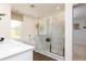A bright bathroom features a glass enclosed shower with marble tile surround, a soaking tub, and access to a walk-in closet at 1771 Jordan Brook Dr, Lawrenceville, GA 30043